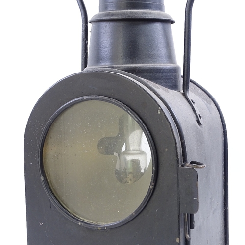 65 - A large black painted railway oil lantern, double-sided glass panels, with carrying handle, overall ... 