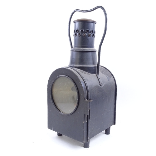 65 - A large black painted railway oil lantern, double-sided glass panels, with carrying handle, overall ... 