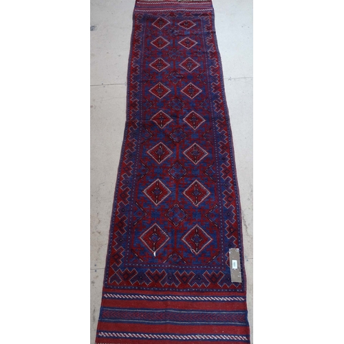 1851 - A Meshwani red ground runner, 256cm x 64cm