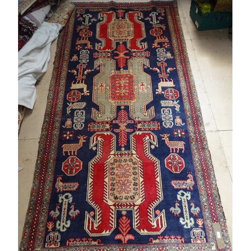 1853 - A blue ground Shirvan carpet, with symmetrical pattern and border, 300cm x 140cm