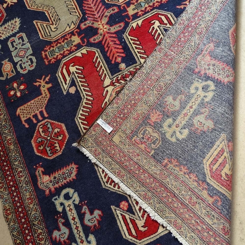 1853 - A blue ground Shirvan carpet, with symmetrical pattern and border, 300cm x 140cm