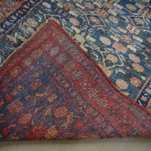 1860 - An Antique red ground Beluchi rug, 210cm x 115cm