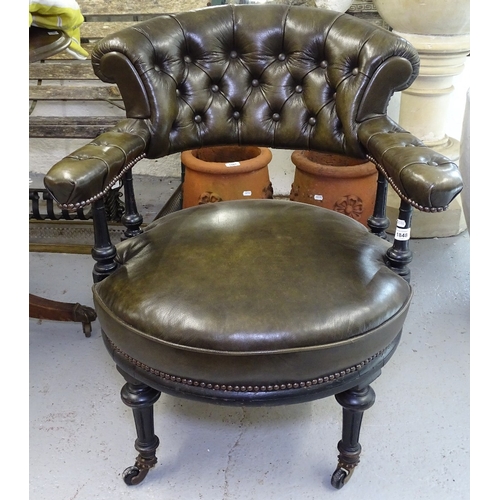 1848 - A Victorian ebonised and studded leather upholstered bow-arm desk chair