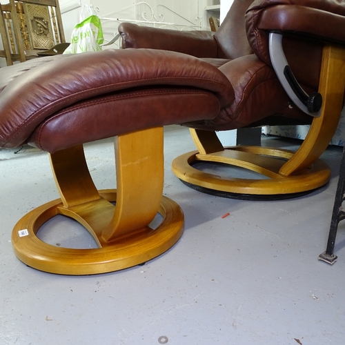 1849 - A Stressless style brown upholstered swivel armchair, with matching footstool