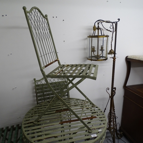 1807 - A painted metal circular garden table, and a pair of matching folding chairs