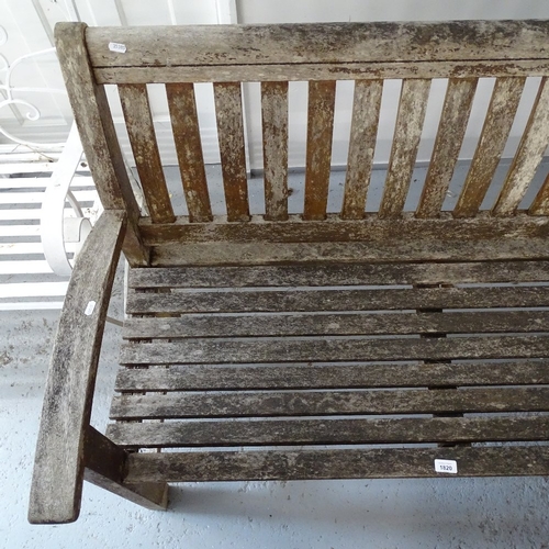 1820 - A slatted hardwood weathered garden bench, W139cm