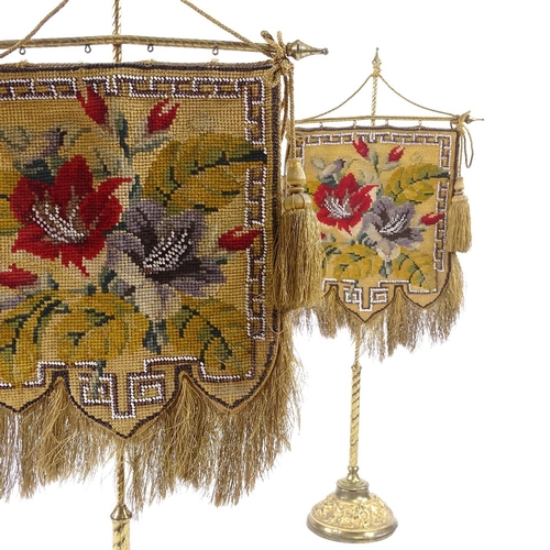 397 - A pair of 19th century Berlin beadwork face screens, mounted on original gilt-brass stands on relief... 