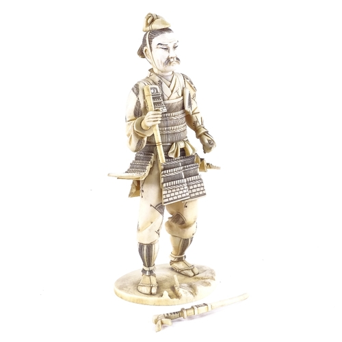 13 - A Japanese ivory carving of a Samurai Warrior, Meiji Period, signed with lacquer seal under base, he... 