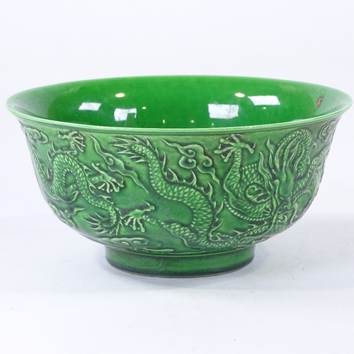 137 - A Chinese green glaze porcelain bowl, with relief moulded dragons, 6 character mark, diameter 16cm