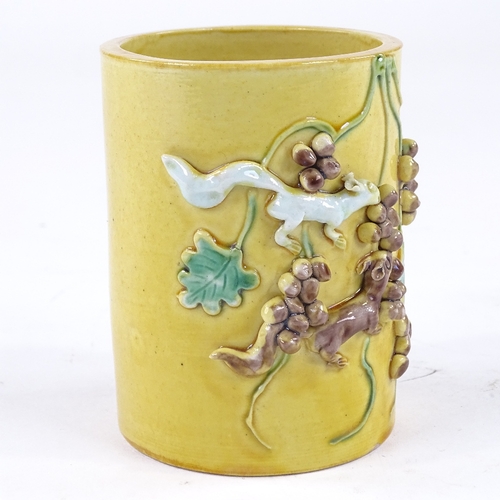 138 - A Chinese yellow glaze porcelain cylinder vase, high relief decorated squirrels and acorns, height 1... 