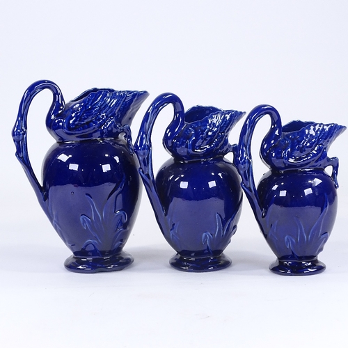 150 - Victorian Aesthetic Movement graduated set of 3 pottery ewers, in the form of swans and bulrushes, c... 