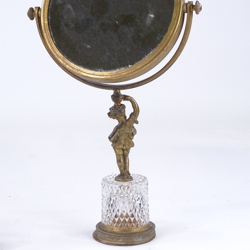 152 - A gilt-bronze and cut-glass shaving mirror, with Classical cherub support, and a cranberry overlay c... 