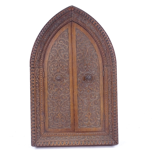 162 - A relief cast patinated spelter icon in original carved wood lancet-topped cabinet, height 27cm