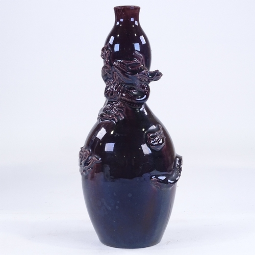 165 - A Chinese dark purple glaze double gourd vase, with entwined dragon, height 24cm