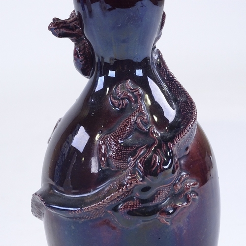 165 - A Chinese dark purple glaze double gourd vase, with entwined dragon, height 24cm