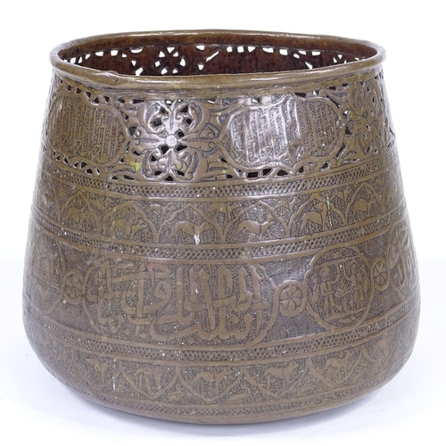 179 - An Islamic engraved brass jardiniere, with pierced frieze and text, rim diameter 21cm, height 22cm