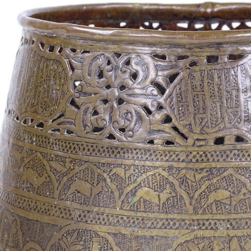 179 - An Islamic engraved brass jardiniere, with pierced frieze and text, rim diameter 21cm, height 22cm