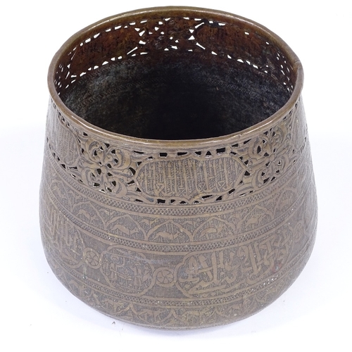 179 - An Islamic engraved brass jardiniere, with pierced frieze and text, rim diameter 21cm, height 22cm