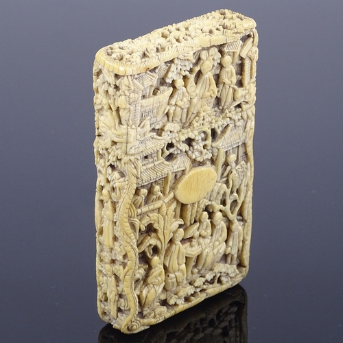 183 - A 19th century Chinese relief carved ivory card case, heavily carved all over with river and garden ... 