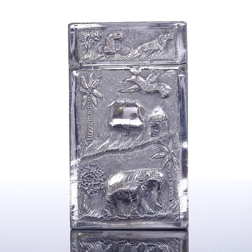 188 - A small Anglo-Indian unmarked white metal card case, with relief cast front and back, 8cm x 4.5cm