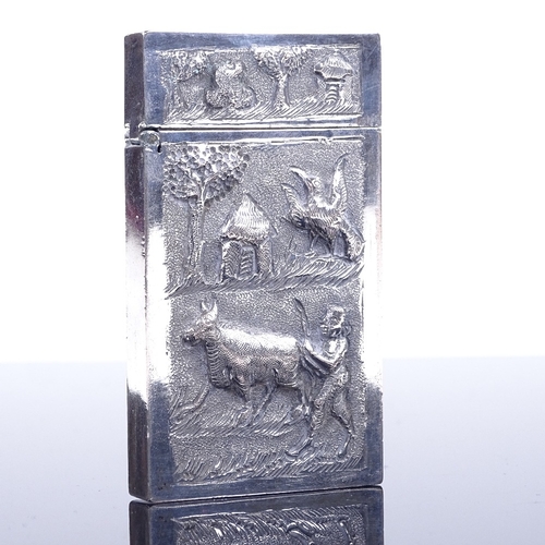 188 - A small Anglo-Indian unmarked white metal card case, with relief cast front and back, 8cm x 4.5cm