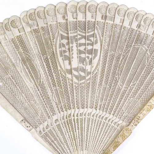 194 - A 19th century Chinese ivory brise fan, with relief carved end panels and carved and pierced sticks,... 