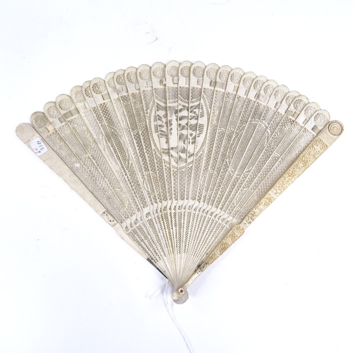 194 - A 19th century Chinese ivory brise fan, with relief carved end panels and carved and pierced sticks,... 