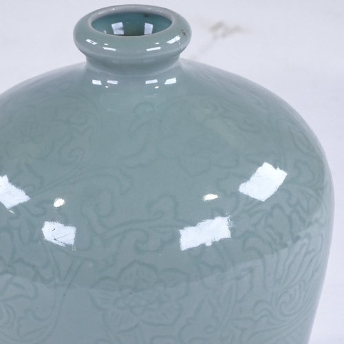 212 - A Chinese celadon glaze bottle vase with incised decoration, height 22cm