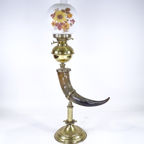 221 - A brass and buffalo horn oil lamp, with opaque glass shade, height to top of shade 75cm