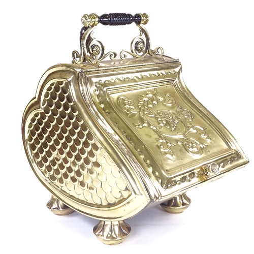 224 - A Victorian embossed brass coal bin, with floral relief decorated hinged lid and shovel