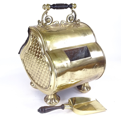 224 - A Victorian embossed brass coal bin, with floral relief decorated hinged lid and shovel