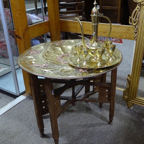 225 - An Islamic copper and brass tray on folding stand, diameter 60cm, and an Islamic brass ewer and gobl... 