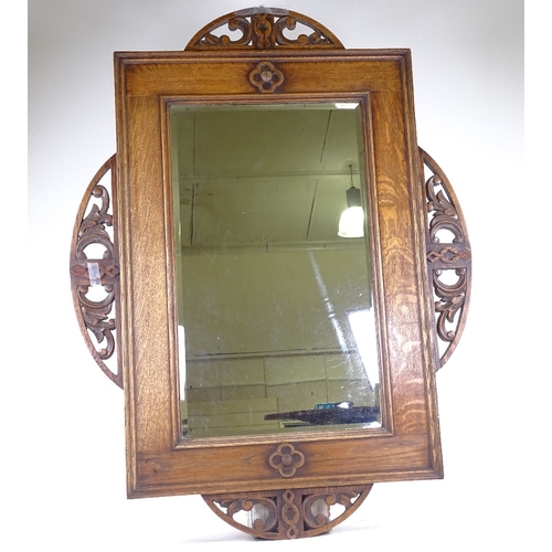 227 - An early 20th century oak-framed wall mirror, with carved and pierced mounts, overall dimensions 98c... 