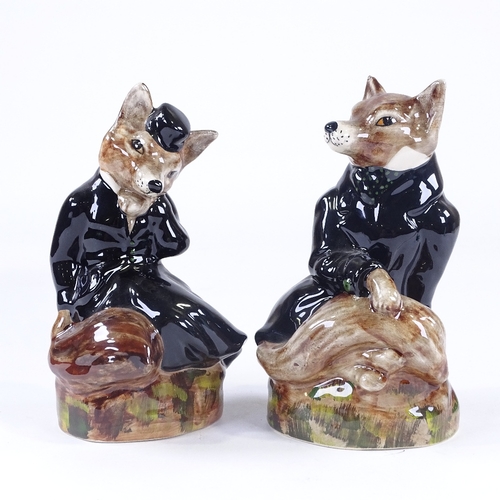 25 - A pair of Staffordshire China hunting foxes in black coats, height 19cm