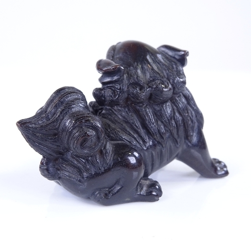 268 - A Japanese carved and stained wood Dog of Fo design netsuke, signed, length 6cm