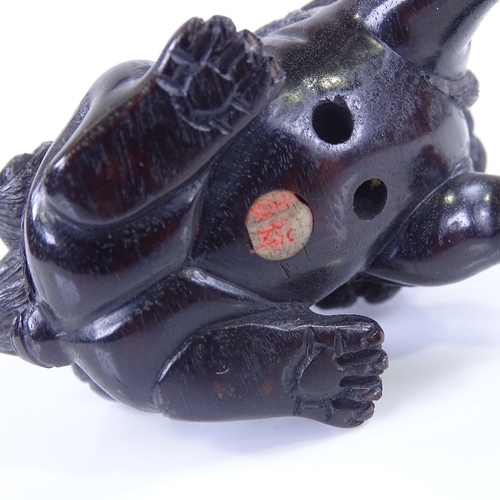 268 - A Japanese carved and stained wood Dog of Fo design netsuke, signed, length 6cm