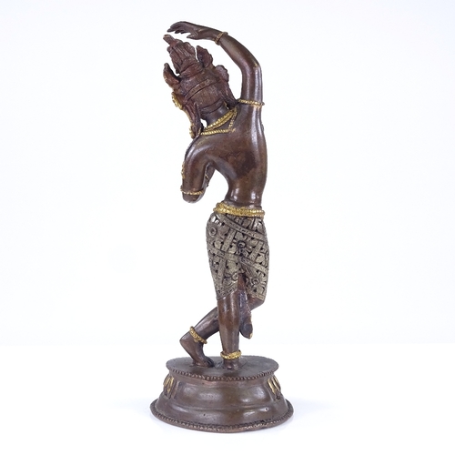 291 - An Indian parcel gilt-bronze dancing Buddha, height 20cm, and a gilt-bronze seated cherub (2)