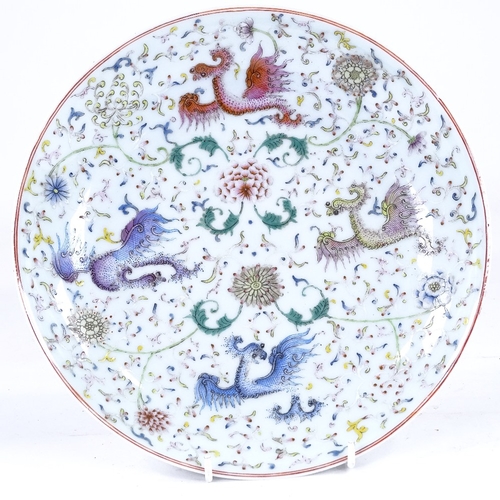 292 - A Chinese porcelain bowl with painted polychrome dragon designs, 6 character mark, diameter 24cm