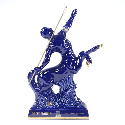 303 - A bottle of Remy Martin Fine Champagne Cognac, presented in a Limoges blue centaur design decanter, ... 