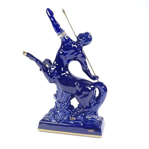 303 - A bottle of Remy Martin Fine Champagne Cognac, presented in a Limoges blue centaur design decanter, ... 