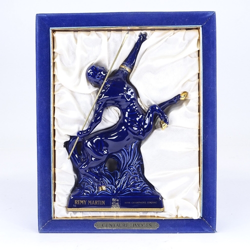 303 - A bottle of Remy Martin Fine Champagne Cognac, presented in a Limoges blue centaur design decanter, ... 