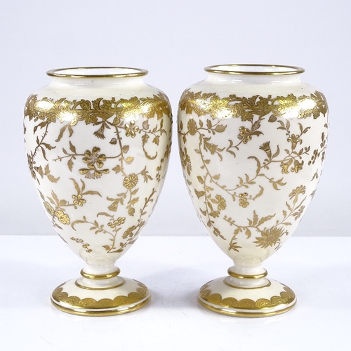 316 - A pair of Minton cream ground china vases with gilded floral decoration, height 13cm