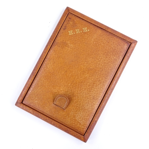 318 - A leather-covered travelling mirror, monogrammed HRH, length 17cm