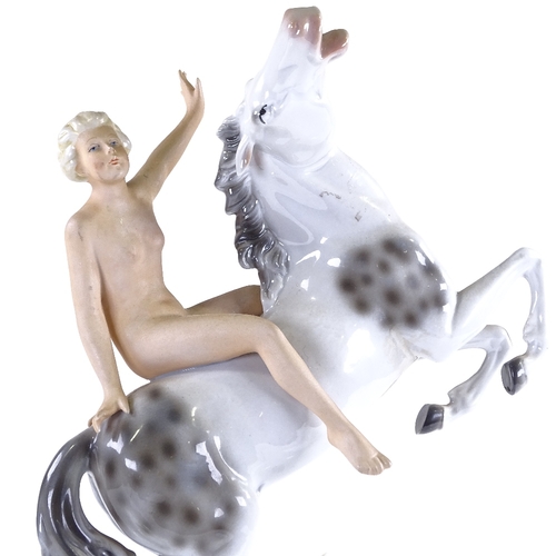 321 - A German porcelain naked figure riding a horse, height 28cm