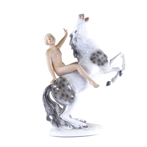 321 - A German porcelain naked figure riding a horse, height 28cm