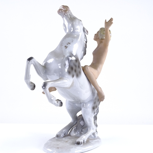 321 - A German porcelain naked figure riding a horse, height 28cm