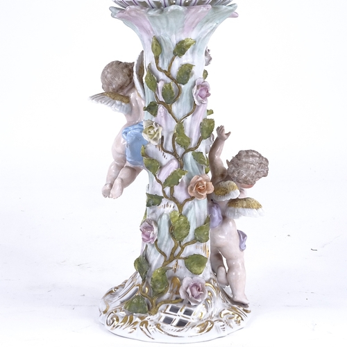 338 - A German porcelain basket on stand, supported by 2 cherubs, height excluding handles 35cm