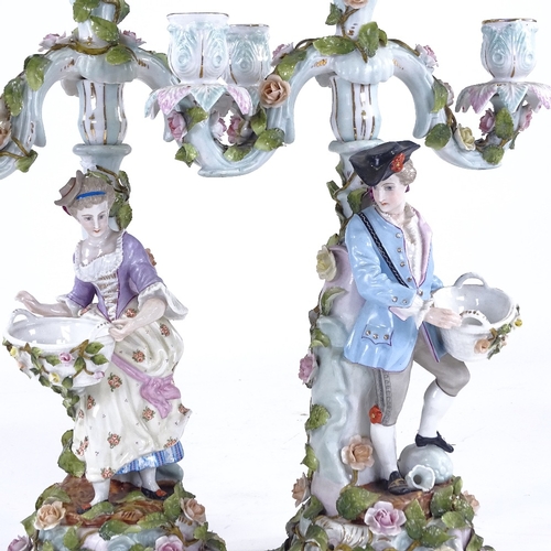 340 - A pair of Continental porcelain 3-branch candelabra, supported by country figures, height 42cm