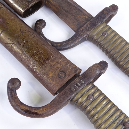 360 - A pair of 19th century sword bayonets with metal scabbards