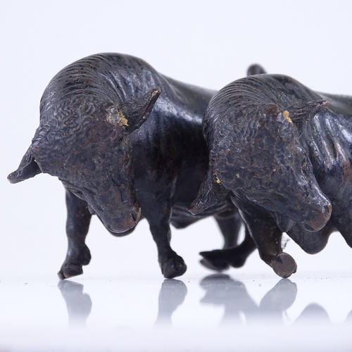 363 - A pair of miniature patinated bronze bulls, length 10cm